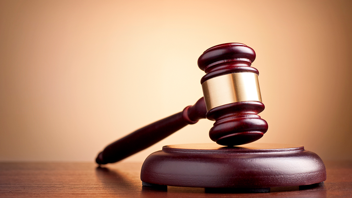 A gavel resting on a sound block, symbolising legal or dispute resolution proceedings.
